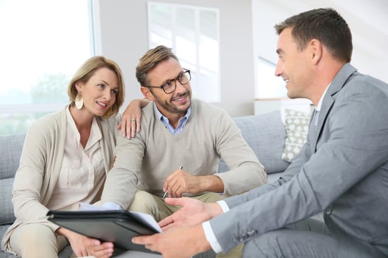 Couple with realtor signing mortgage contract-1