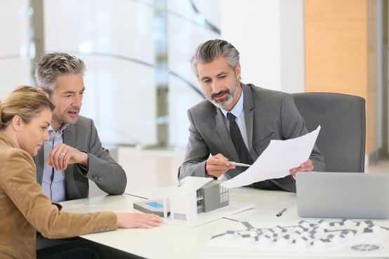 Mature couple meeting architect for construction project-1
